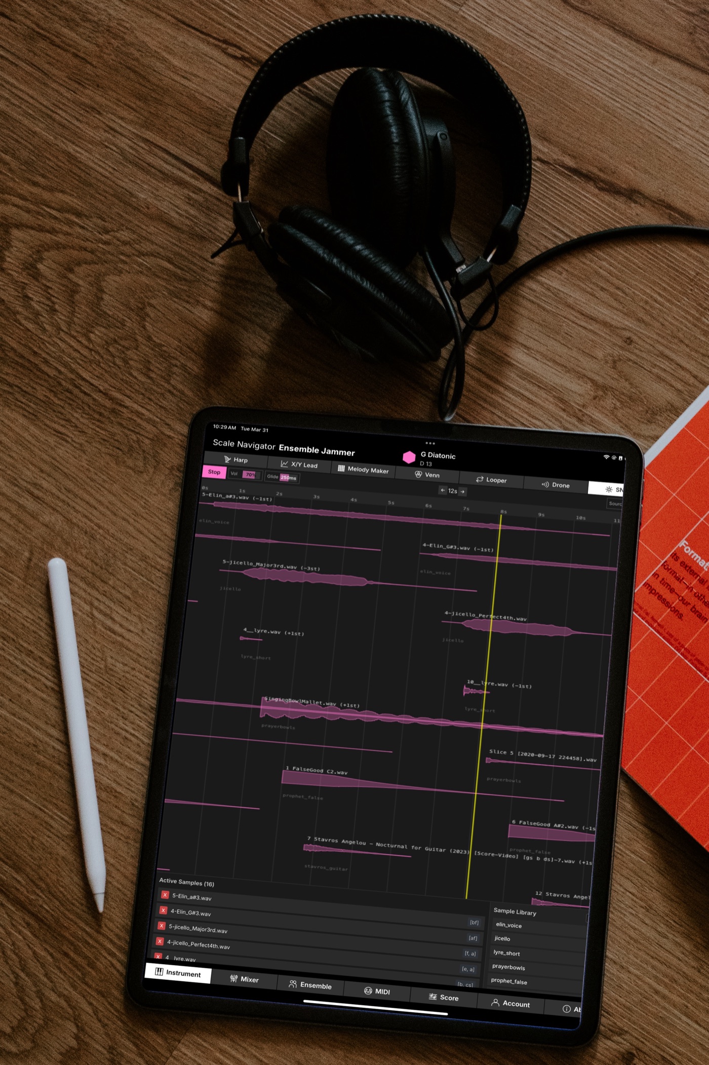 The Sequencer on an iPad lying on a wooden table next to headphones: samples laid out on a timeline, with the shared sample library panel open